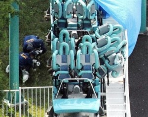Police officers investigate the site of a roller coaster accident in Suita, western Japan, Saturday, May 5, 2007. A roller coaster traveling up to 75 kilometers (46 miles) per hour hit a guardrail at an amusement park in western Japan on Saturday, killing one person and injuring 21 others, officials said. (AP Photo/Kyodo News) ** JAPAN OUT, NO SALES, MANDATORY CREDIT 